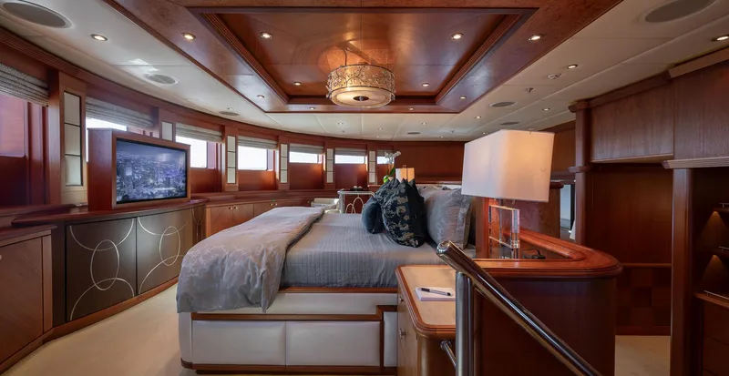 Skyfall Yacht Photos Pics Luxurious 2010 Trinity Yachts motor yacht bedroom with elegant wood finishes and modern amenities.