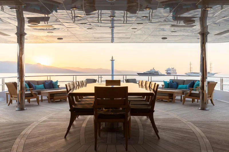 Skyfall Yacht Photos Pics Luxurious 2010 Trinity Yachts motor yacht deck with elegant dining area at sunset.