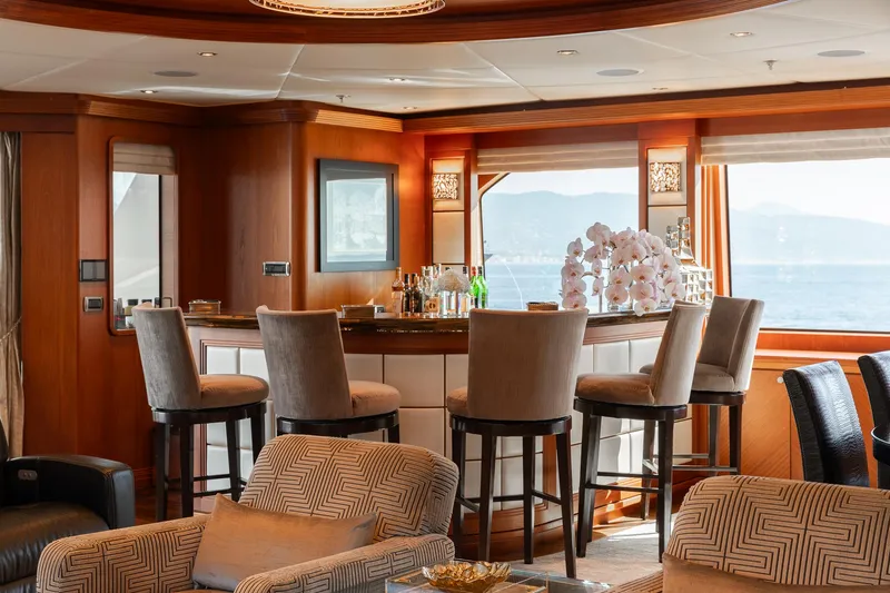 Skyfall Yacht Photos Pics Luxurious interior of 2010 Trinity Yachts motor yacht with elegant bar and seating area.