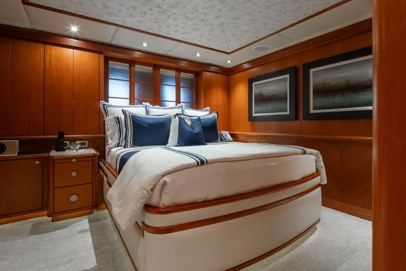Skyfall Yacht Photos Pics Luxurious bedroom interior of 2010 Trinity Yachts motor yacht with elegant wood paneling.