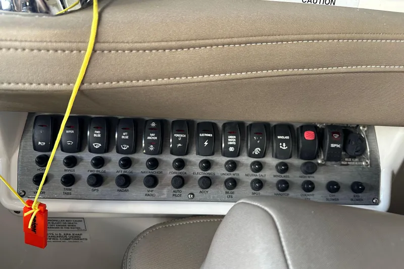 Just Traded Yacht Photos Pics Control panel of a 2014 Regal 35 Sport Coupe boat with labeled switches.