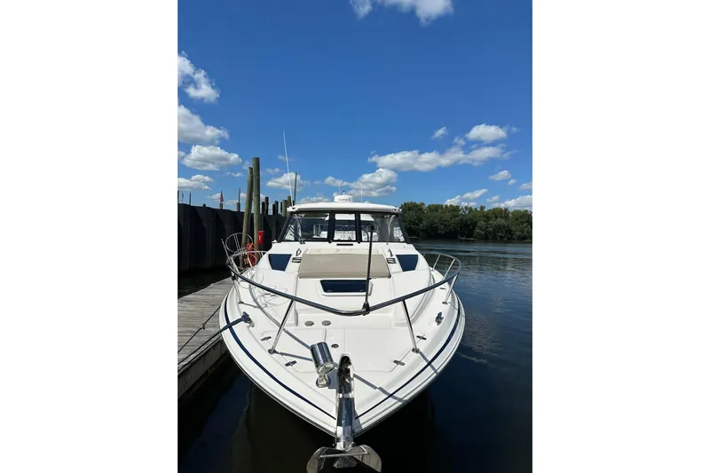 Just Traded Yacht Photos Pics 2014 Regal 35 Sport Coupe docked on a sunny day with blue skies.