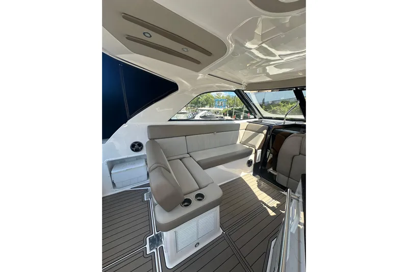 Just Traded Yacht Photos Pics Interior of 2014 Regal 35 Sport Coupe with beige seating and modern design.