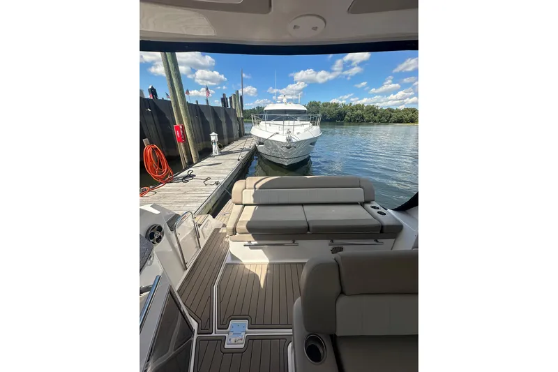 Just Traded Yacht Photos Pics 2014 Regal 35 Sport Coupe docked, view from interior, sunny day, calm water.