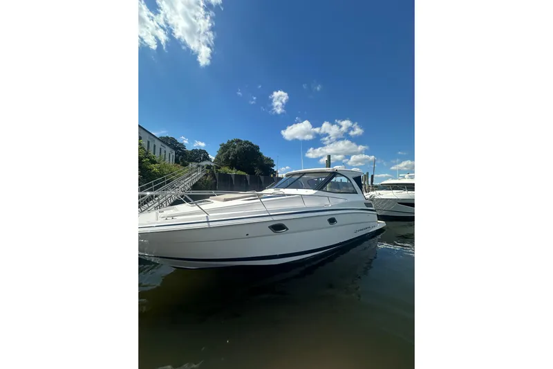 Just Traded Yacht Photos Pics 2014 Regal 35 Sport Coupe boat docked under a clear blue sky.