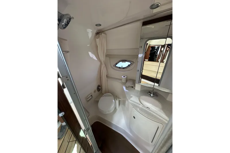 Just Traded Yacht Photos Pics 2014 Regal 35 Sport Coupe bathroom with modern fixtures and compact design.