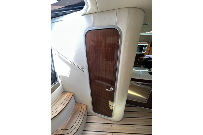 Just Traded Yacht Photos Pics Interior of 2014 Regal 35 Sport Coupe with wooden door and steps.