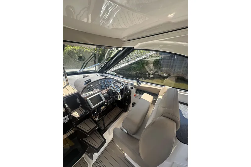 Just Traded Yacht Photos Pics 2014 Regal 35 Sport Coupe cockpit with modern controls and comfortable seating.