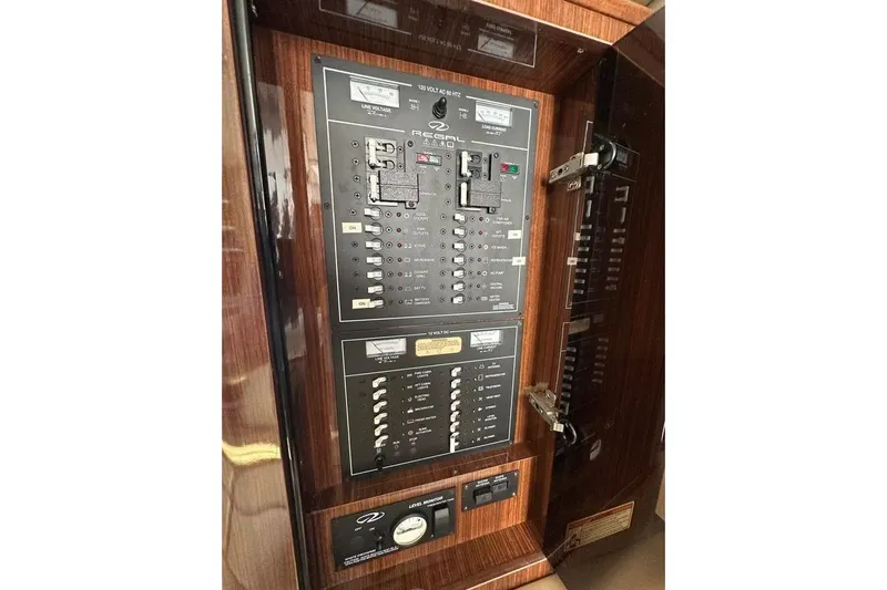 Just Traded Yacht Photos Pics Electrical panel of a 2014 Regal 35 Sport Coupe boat, featuring switches and controls.