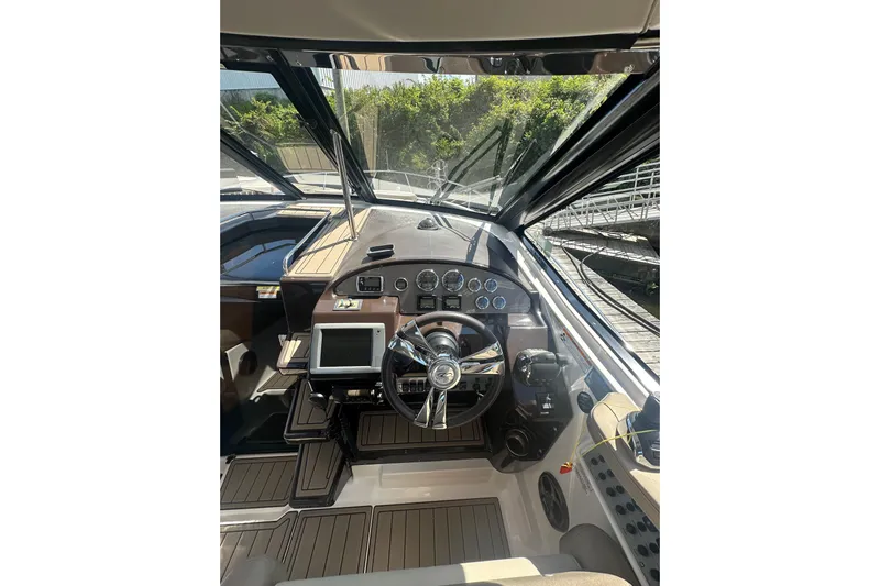 Just Traded Yacht Photos Pics 2014 Regal 35 Sport Coupe helm with modern controls and navigation system.