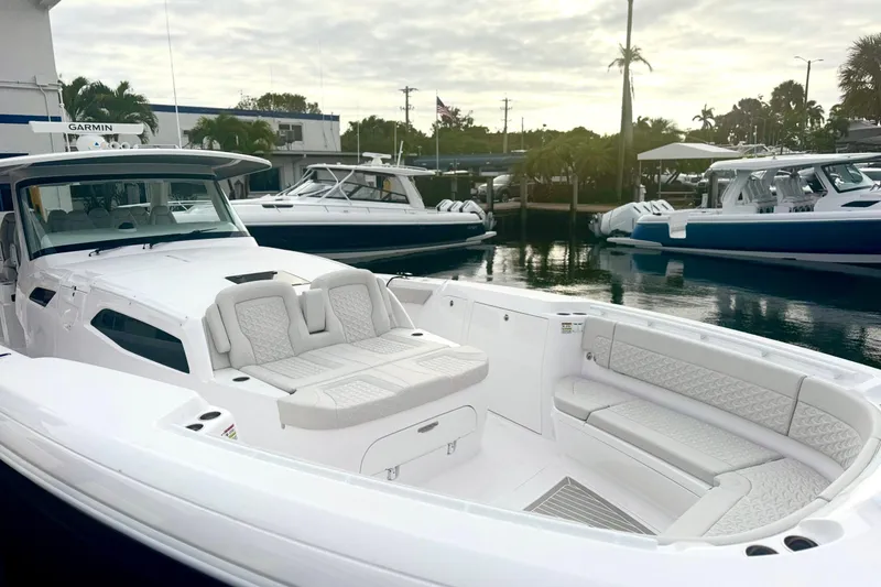  Yacht Photos Pics Luxurious 2025 Intrepid 51 Panacea boat with sleek design and spacious seating at marina.