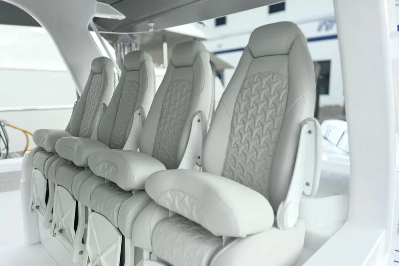  Yacht Photos Pics Luxurious seating on the 2025 Intrepid 51 Panacea boat, featuring elegant design and comfort.