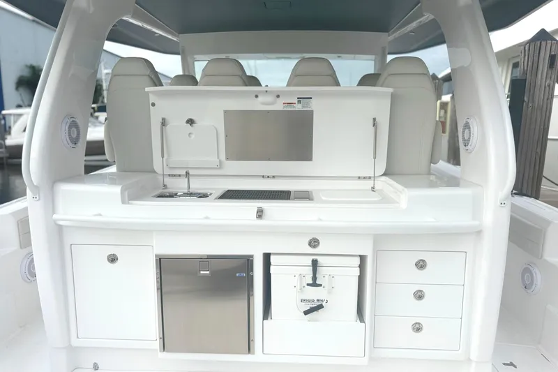  Yacht Photos Pics 2025 Intrepid 51 Panacea boat interior with sleek white cabinetry and modern amenities.