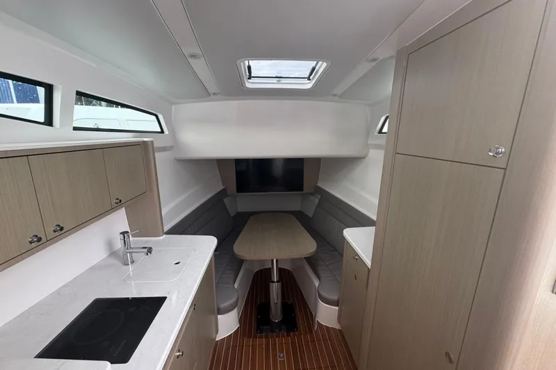  Yacht Photos Pics Luxurious interior of 2025 Intrepid 51 Panacea yacht with modern kitchen and seating area.