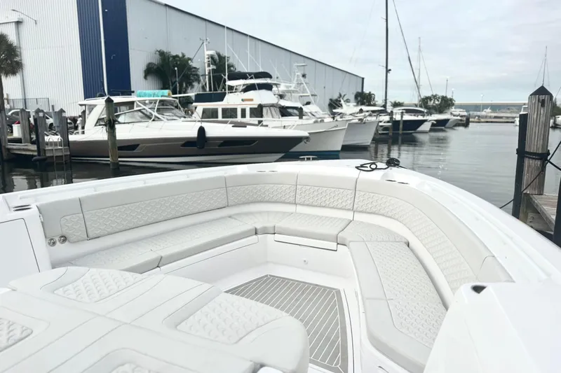  Yacht Photos Pics 2025 Intrepid 51 Panacea luxury boat docked at marina with sleek seating area.