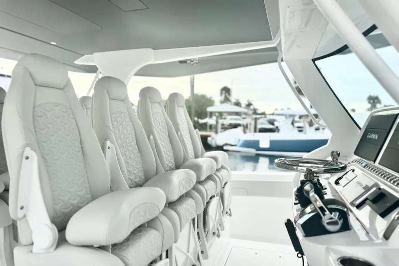  Yacht Photos Pics Luxurious interior of 2025 Intrepid 51 Panacea yacht with plush seating and advanced navigation.