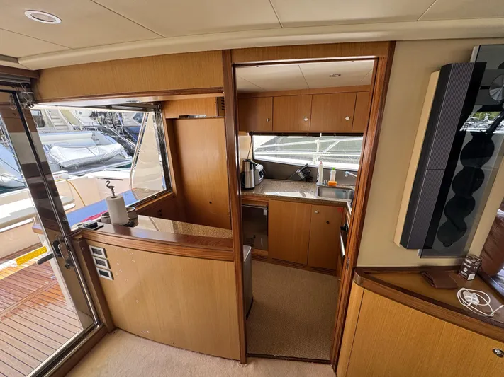  Yacht Photos Pics Interior of 2007 Ferretti Yachts 630, featuring a compact kitchen and wooden cabinetry.