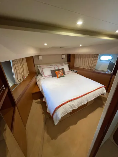  Yacht Photos Pics Luxurious bedroom in a 2007 Ferretti Yachts 630, featuring elegant bedding and ambient lighting.