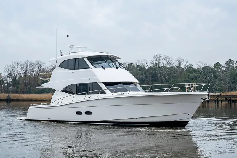 Tank Woo Yacht Photos Pics 2018 Maritimo M54 yacht cruising on a calm river with trees in the background.