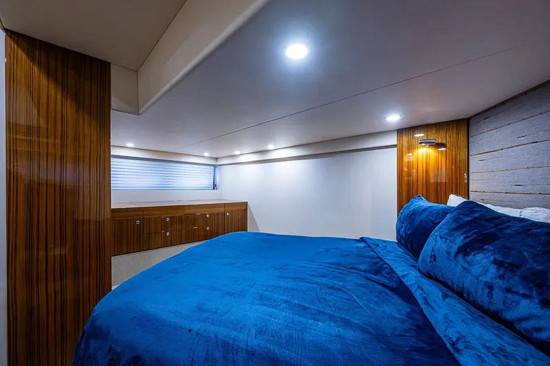 Tank Woo Yacht Photos Pics Luxurious cabin interior of 2018 Maritimo M54 yacht with blue bedding and wood accents.