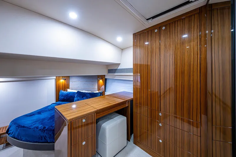 Tank Woo Yacht Photos Pics Luxurious cabin interior of 2018 Maritimo M54 yacht with wood finish and blue bedding.