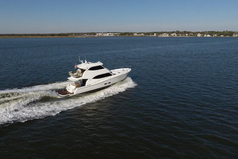 Tank Woo Yacht Photos Pics 2018 Maritimo M54 yacht cruising on open water under clear blue sky.