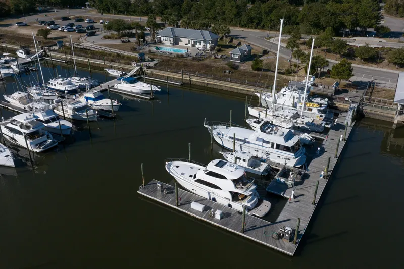 Tank Woo Yacht Photos Pics Aerial view of a marina featuring a 2018 Maritimo M54 yacht docked among other boats.