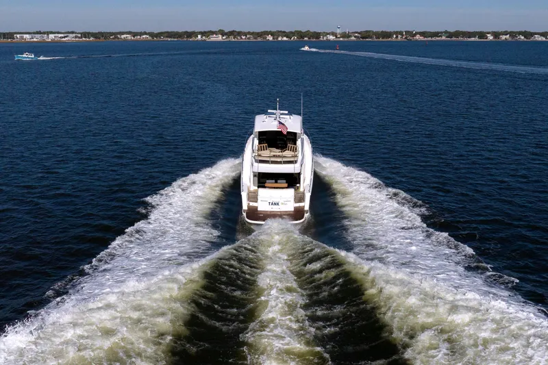 Tank Woo Yacht Photos Pics 2018 Maritimo M54 yacht cruising on open water, leaving a wake behind.