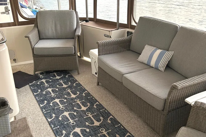 Fathom This Yacht Photos Pics Interior of 2001 Sea Ray 420 Aft Cabin with wicker furniture and nautical-themed decor.