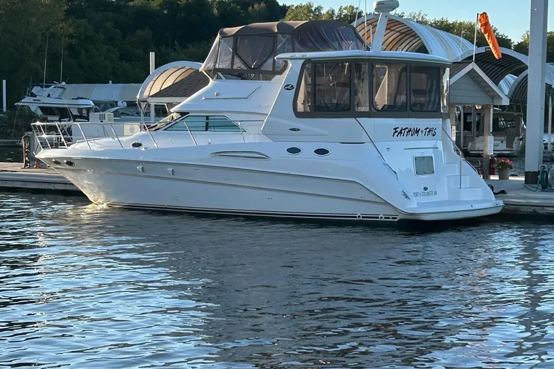 Fathom This Yacht Photos Pics 2001 Sea Ray 420 Aft Cabin yacht docked at marina, reflecting on calm water.