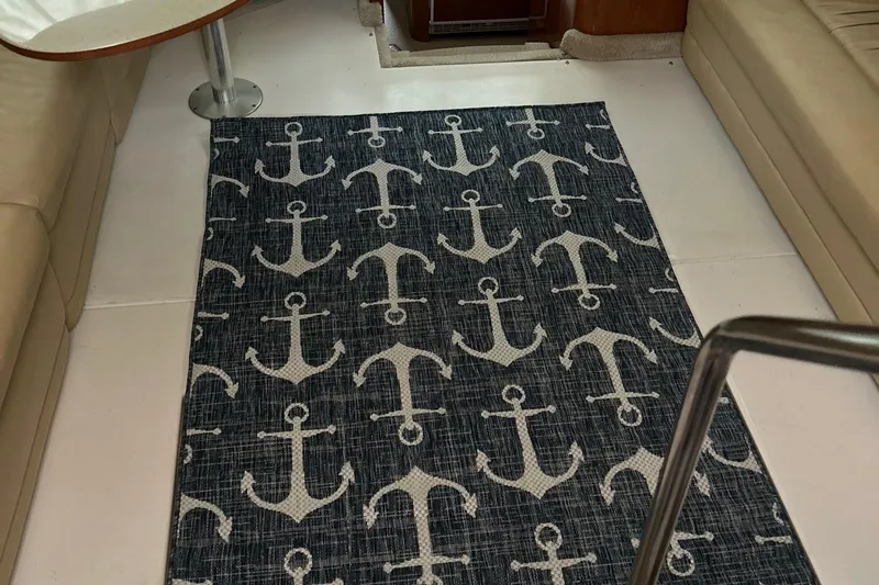 Fathom This Yacht Photos Pics Nautical-themed rug with anchor pattern in 2001 Sea Ray 420 Aft Cabin interior.