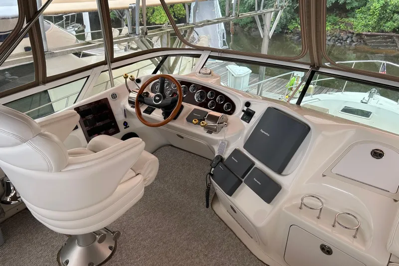Fathom This Yacht Photos Pics Helm of 2001 Sea Ray 420 Aft Cabin yacht with steering wheel and control panels.