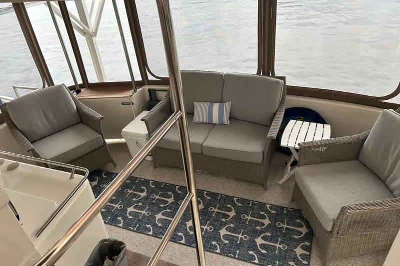 Fathom This Yacht Photos Pics 2001 Sea Ray 420 Aft Cabin interior with wicker seating and nautical decor.