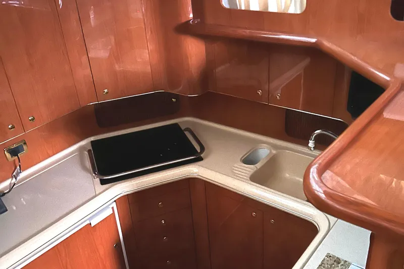 Fathom This Yacht Photos Pics 2001 Sea Ray 420 Aft Cabin kitchen with wood cabinetry and modern sink.