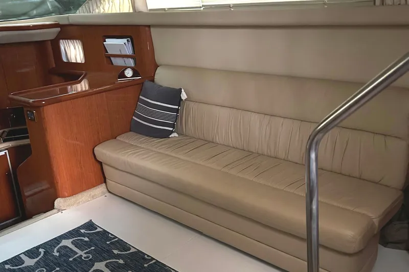 Fathom This Yacht Photos Pics 2001 Sea Ray 420 Aft Cabin interior with beige leather sofa and wooden accents.