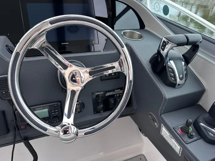 Sojourner Yacht Photos Pics 2024 Regal 33 XO boat helm with steering wheel and controls.