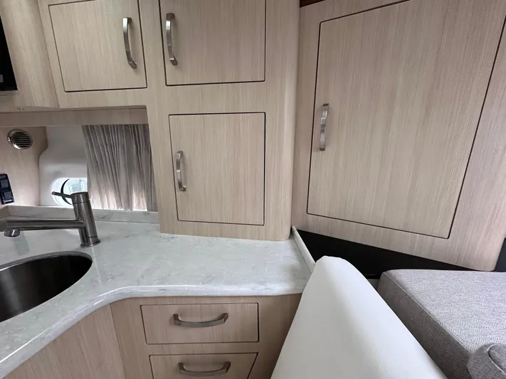 Sojourner Yacht Photos Pics 2024 Regal 33 XO yacht interior with modern cabinetry and sleek countertop design.
