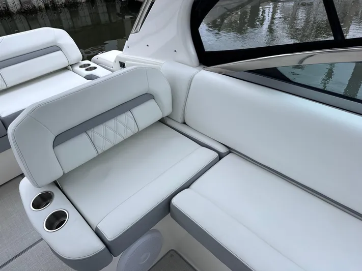 Sojourner Yacht Photos Pics 2024 Regal 33 XO boat interior with white leather seating and cup holders.