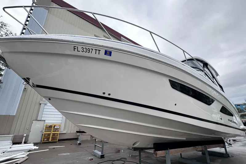 Sojourner Yacht Photos Pics 2024 Regal 33 XO boat on stands, white hull, dockside view.