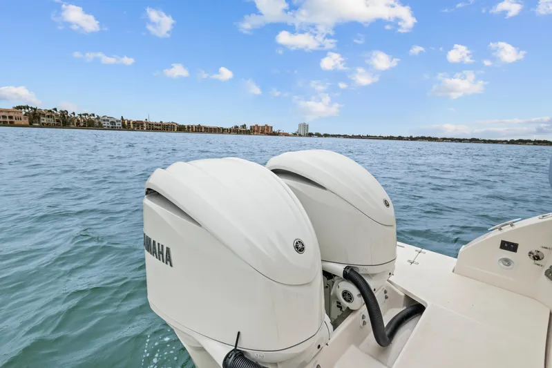 Sojourner Yacht Photos Pics 2024 Regal 33 XO boat with dual Yamaha outboard engines on a calm sea.