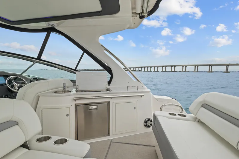 Sojourner Yacht Photos Pics 2024 Regal 33 XO yacht interior with ocean view and bridge in background.