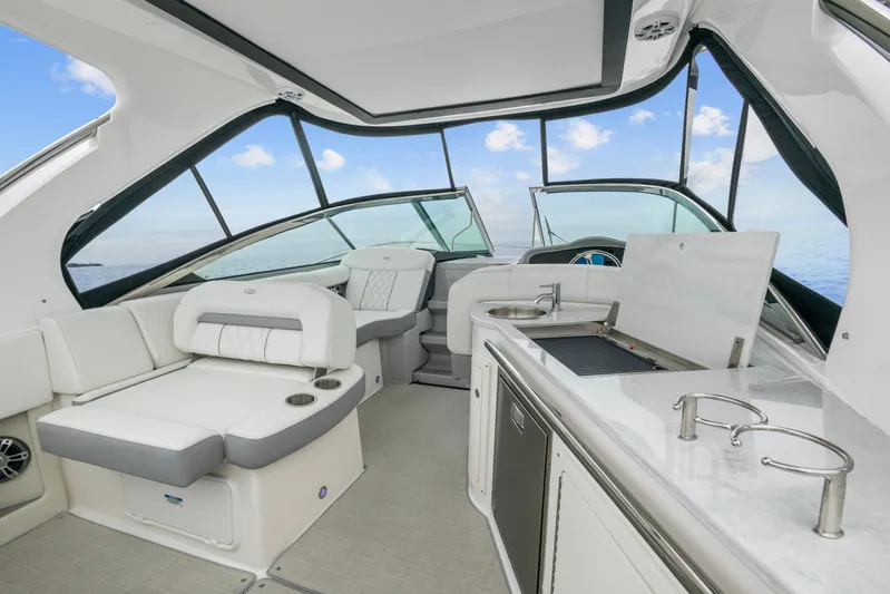 Sojourner Yacht Photos Pics 2024 Regal 33 XO yacht interior with luxurious seating and modern kitchenette.