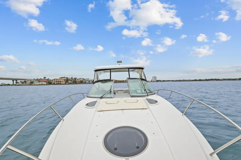 Sojourner Yacht Photos Pics 2024 Regal 33 XO boat on calm water under a blue sky.