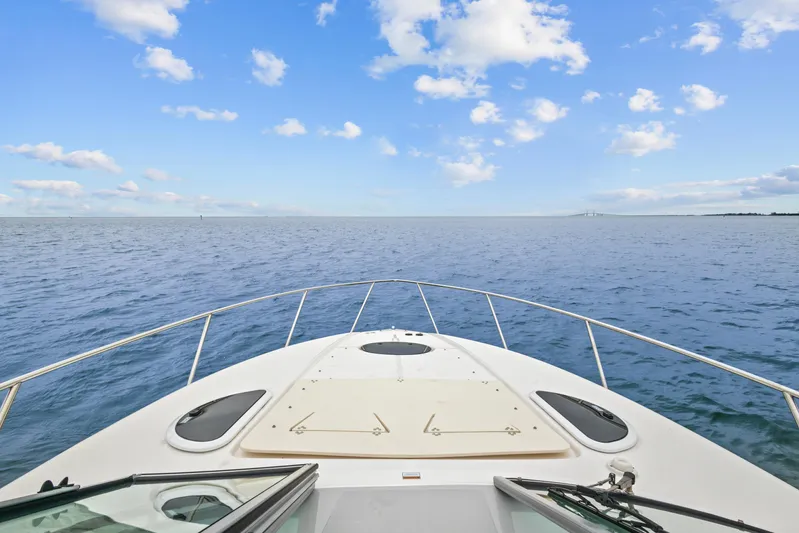 Sojourner Yacht Photos Pics 2024 Regal 33 XO boat cruising on open water under a clear blue sky.