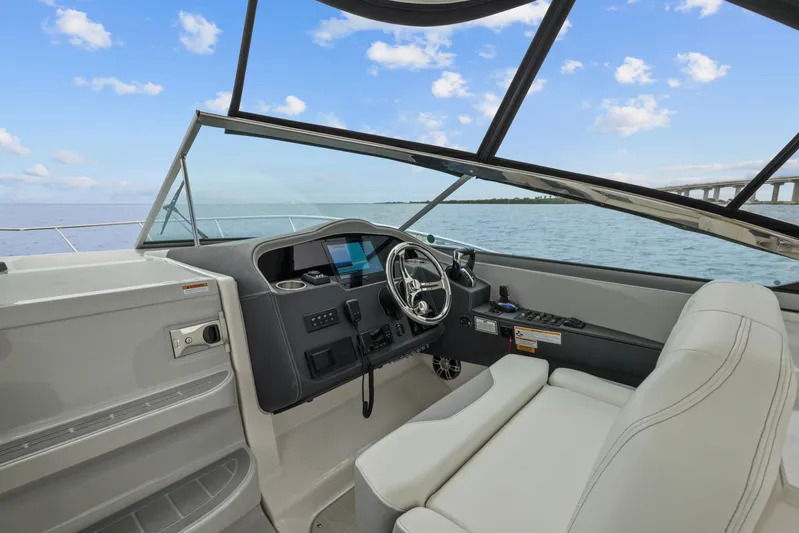 Sojourner Yacht Photos Pics 2024 Regal 33 XO boat cockpit with modern steering and navigation system.