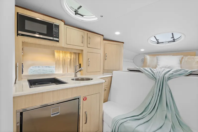 Sojourner Yacht Photos Pics 2024 Regal 33 XO yacht interior with kitchenette and cozy sleeping area.
