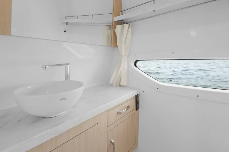 Sojourner Yacht Photos Pics 2024 Regal 33 XO boat interior with modern sink and ocean view window.