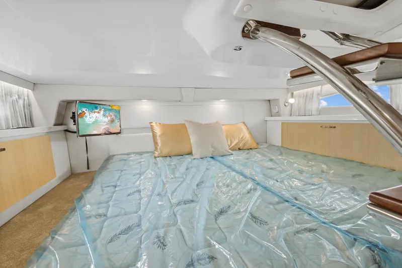 Sojourner Yacht Photos Pics 2024 Regal 33 XO cabin interior with bed, TV, and modern decor.