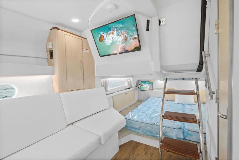 Sojourner Yacht Photos Pics 2024 Regal 33 XO interior with modern seating, TV, and ladder to upper deck.