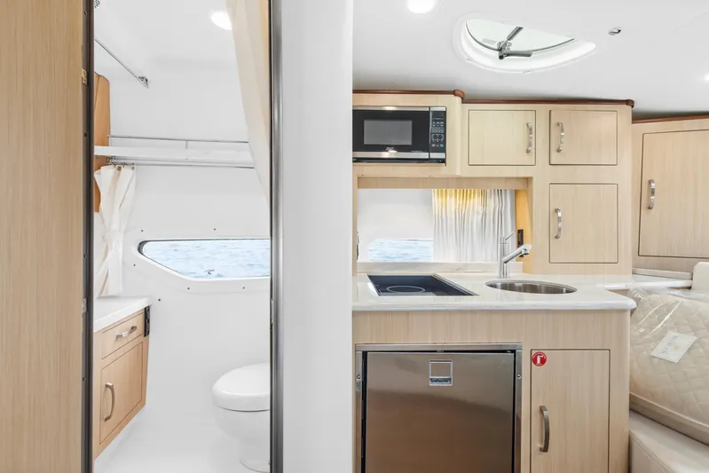 Sojourner Yacht Photos Pics 2024 Regal 33 XO yacht interior with modern kitchen and bathroom amenities.